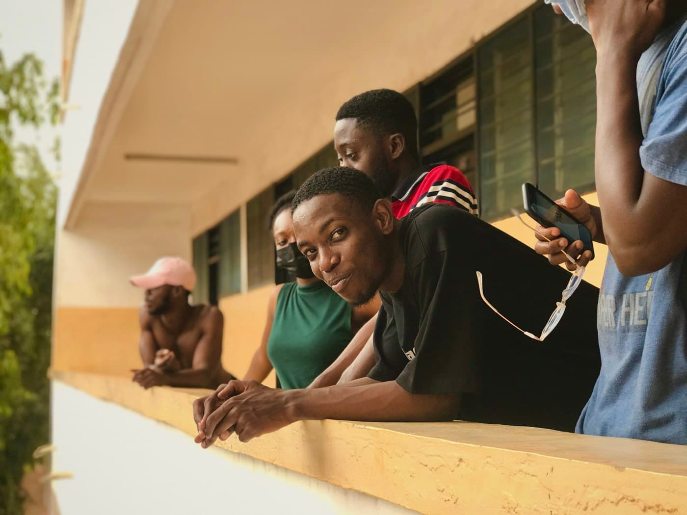 Friends on a campus corridor looking at a phone