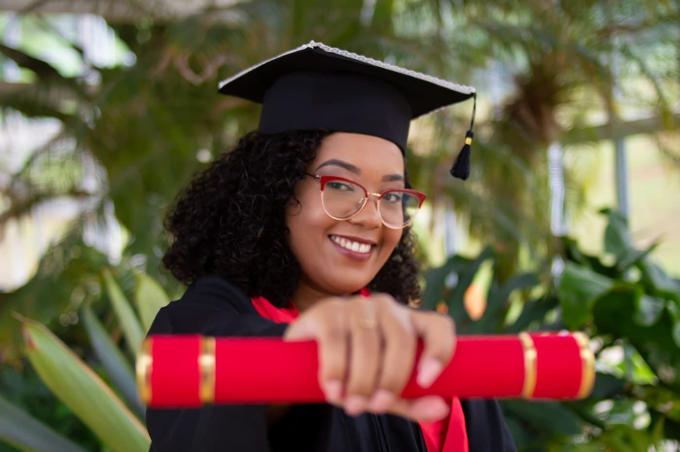 A smiling graduate holding her certificate